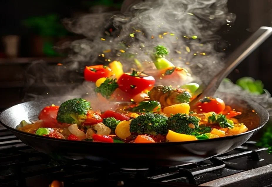 A pan of colourful chicken and vegetable stir fry with steam rising